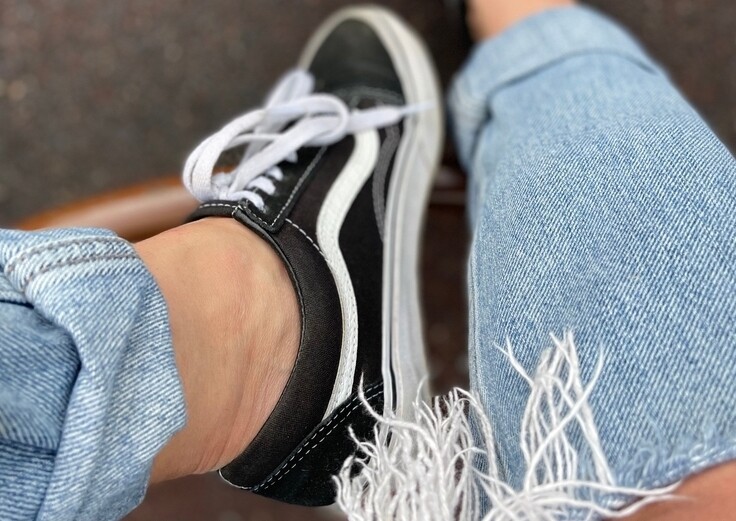 ripped jeans and a pair of vans