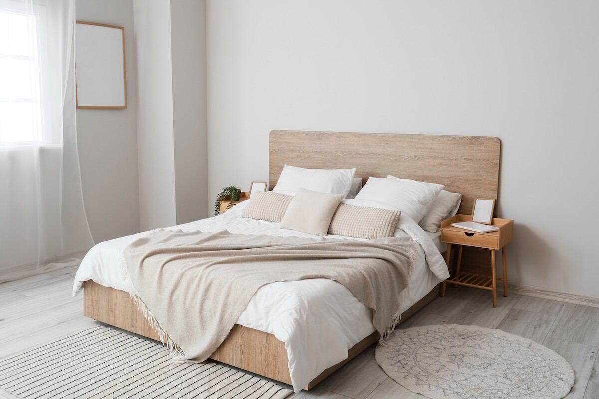 Comfortable bed and nightstands in room